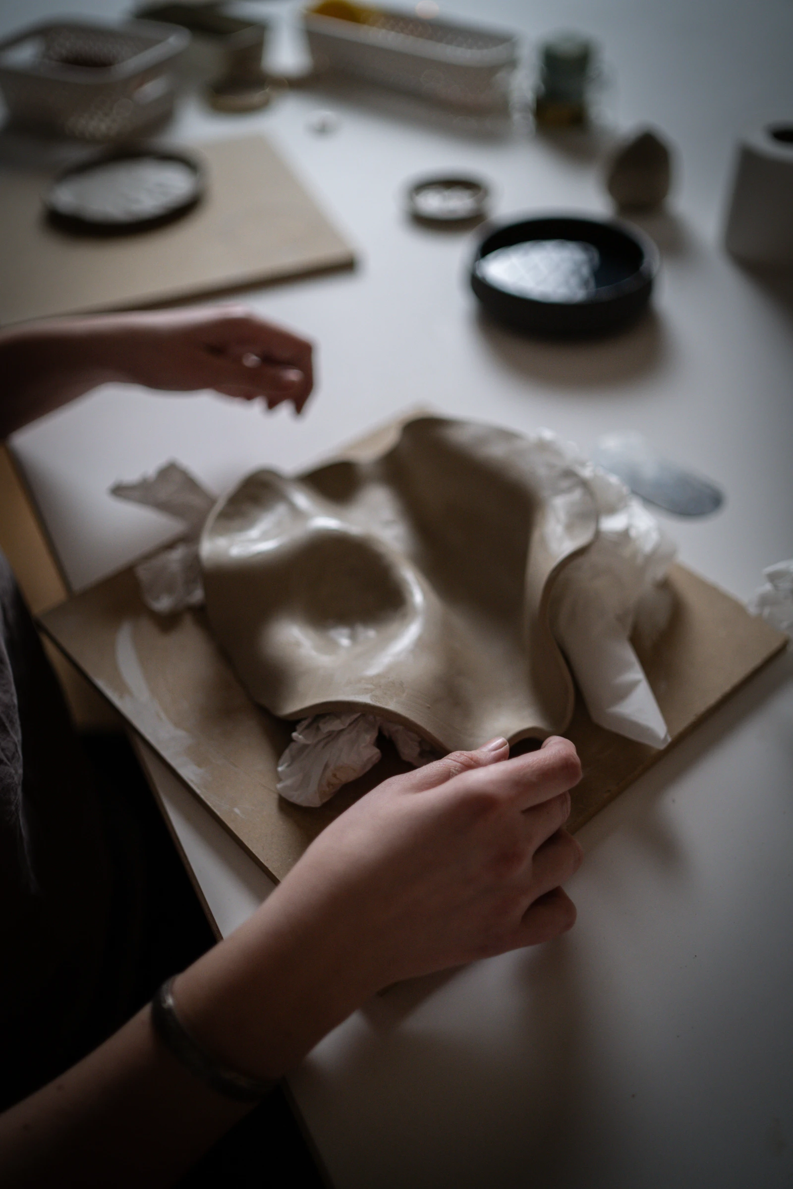Hands shaping clay at Studio Esja